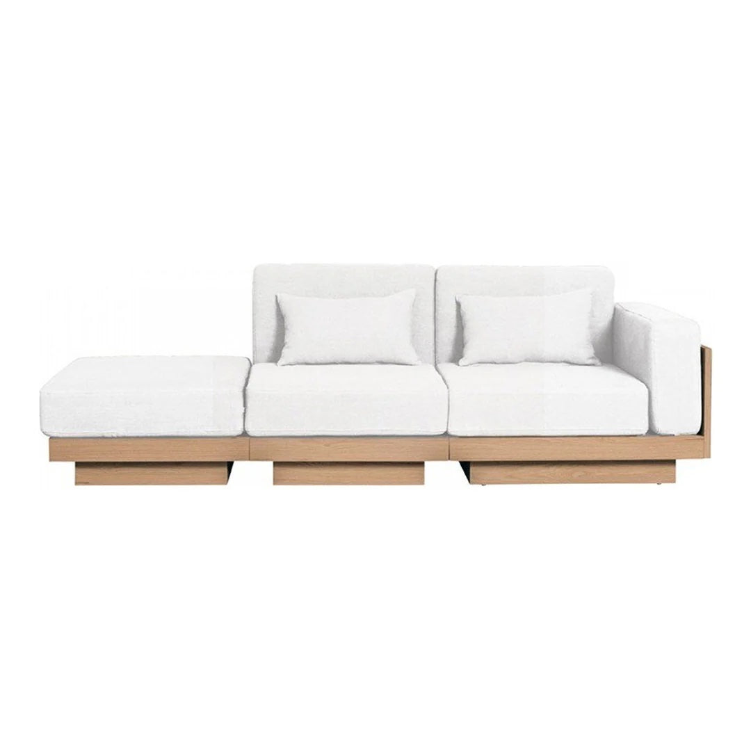 White sectional sofa with clean lines and modern wood base, featuring plush cushions for a minimalist aesthetic.