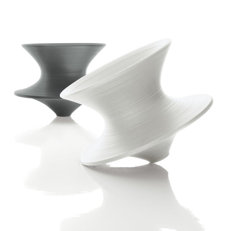 "Two sculptural vases in matte black and white, featuring a smooth, swirling pattern for modern decor accents."