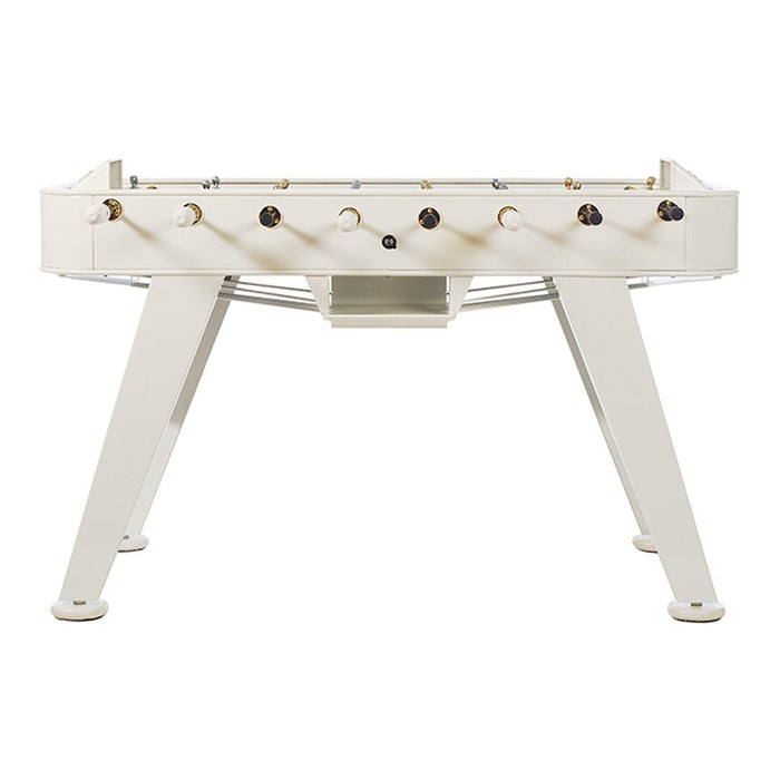 White foosball table with sleek design and gold accents on knobs, offering a modern and minimalist look.