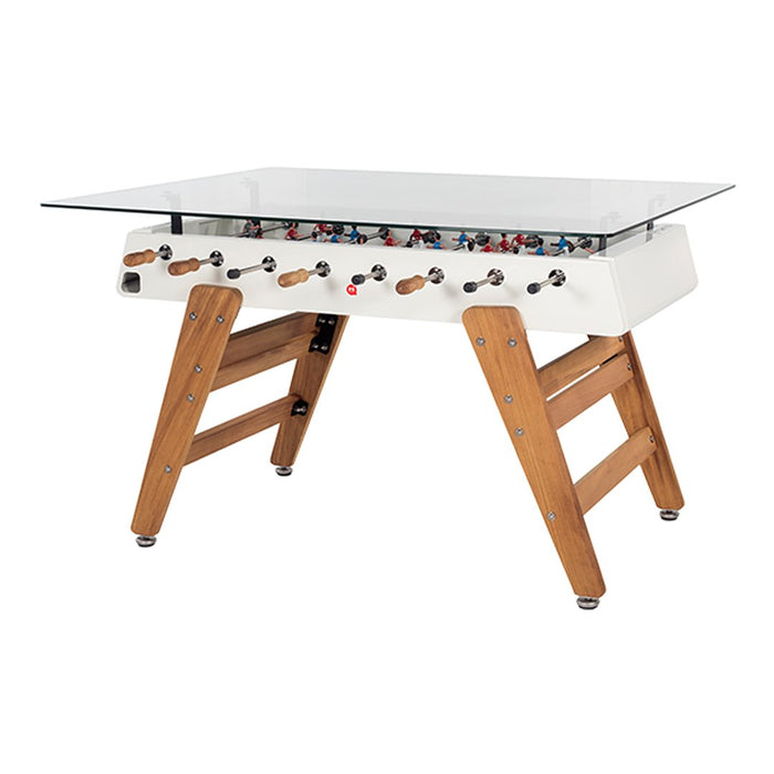 Modern foosball table with a white finish, wooden legs, and colorful player patterns in red and blue.