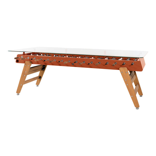 Rust orange tabletop with natural wood legs and silver accents, featuring a sleek glass top for a modern look.