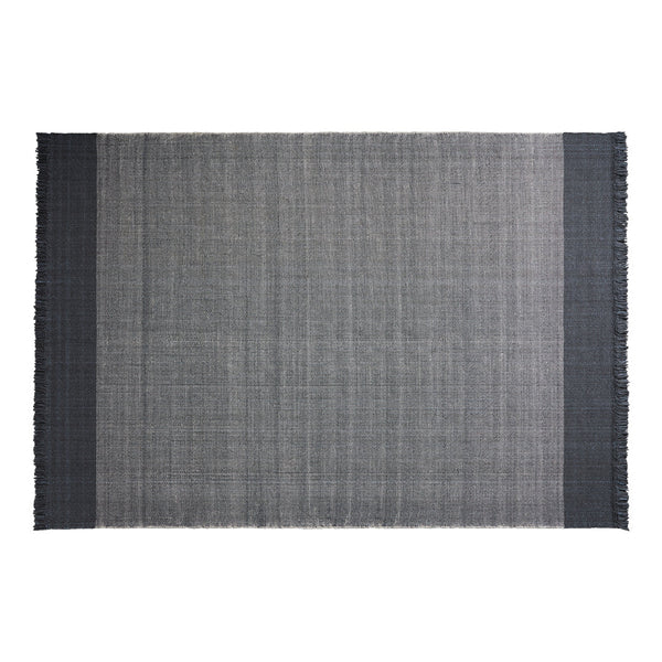 Gray woven rug with fringe, featuring a sophisticated checkered pattern in dark and light tones.