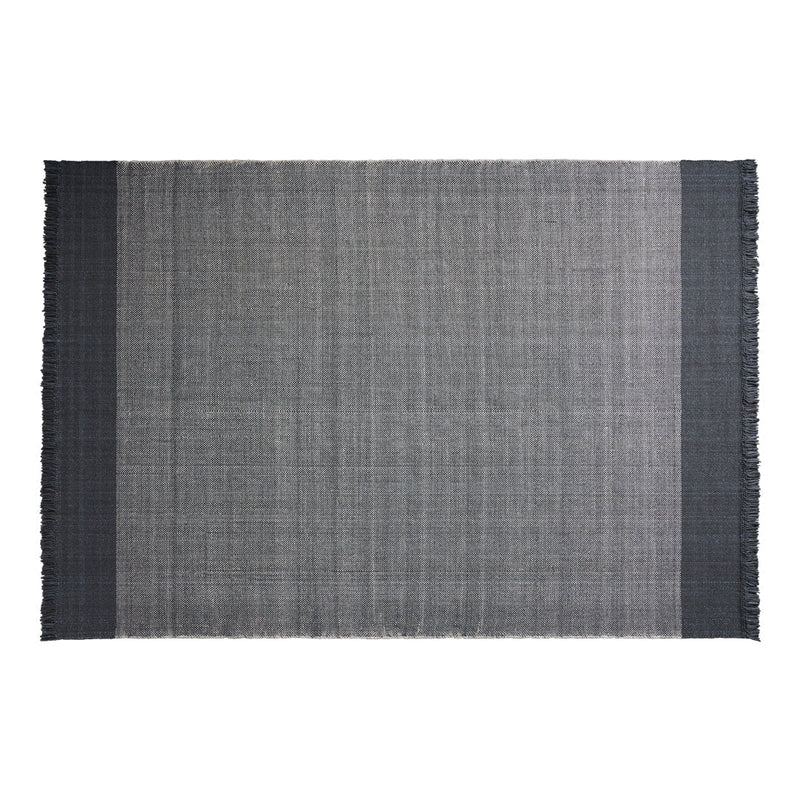 Gray woven rug with fringe, featuring a sophisticated checkered pattern in dark and light tones.