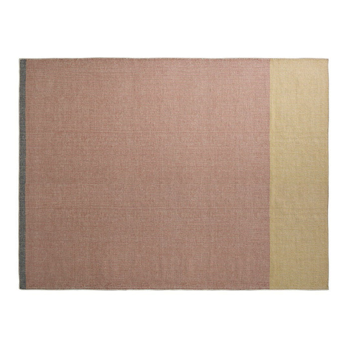 "Textured rug in soft pink and beige with a subtle woven pattern, perfect for modern decor."