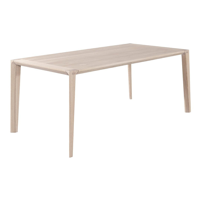 Light wood dining table with a smooth, beige finish and minimalist design. Perfect for modern interiors.