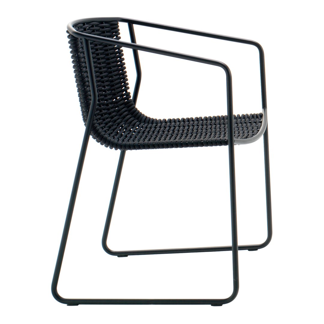 Black woven chair with a modern, minimalist design featuring a slim metal frame and textured seat pattern.