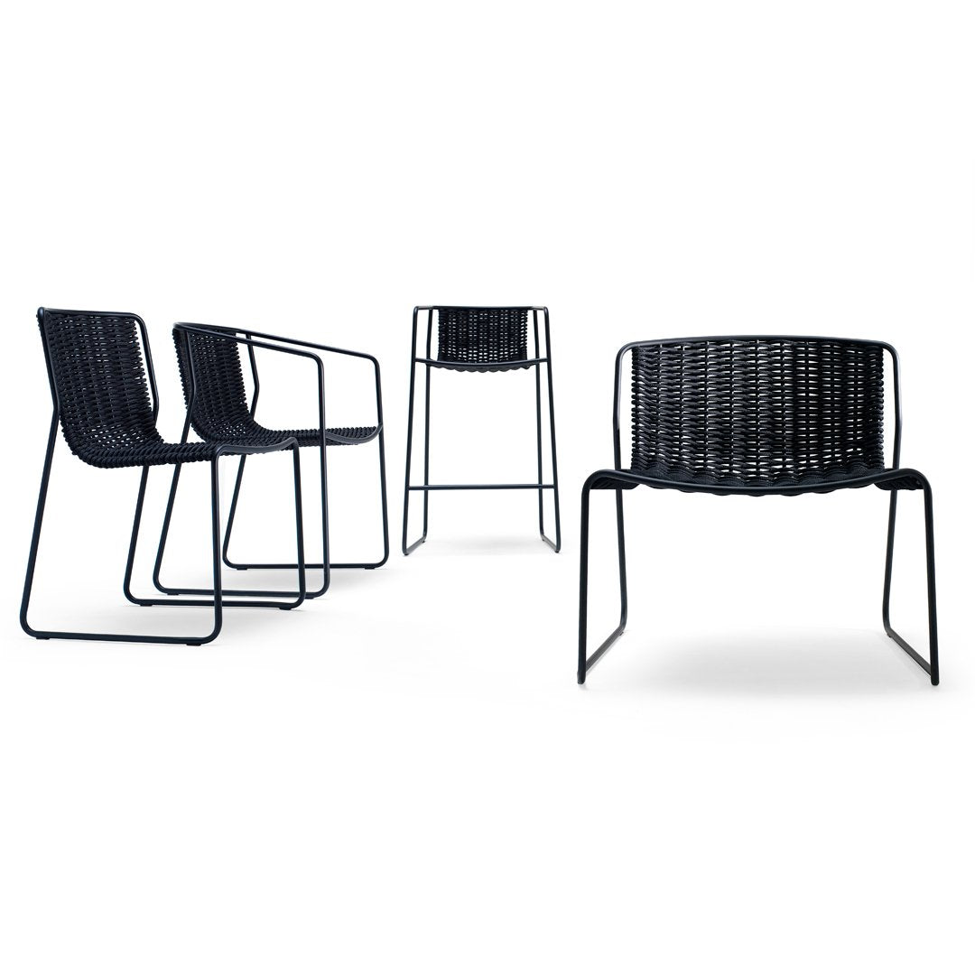Set of four modern chairs in black woven pattern with sleek metal frames, ideal for contemporary decor.