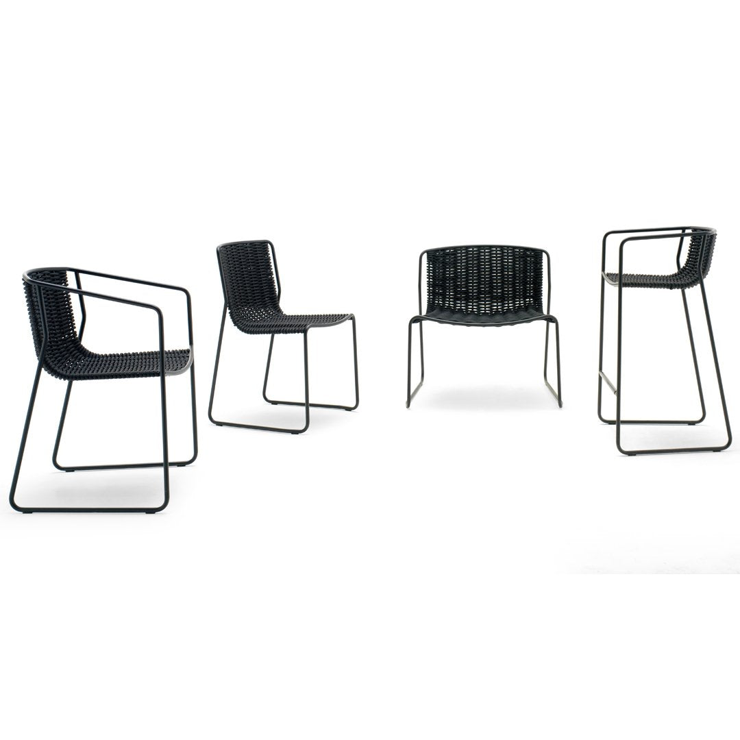 Set of four modern chairs featuring a sleek black metal frame and woven pattern seat in contrasting black tones.