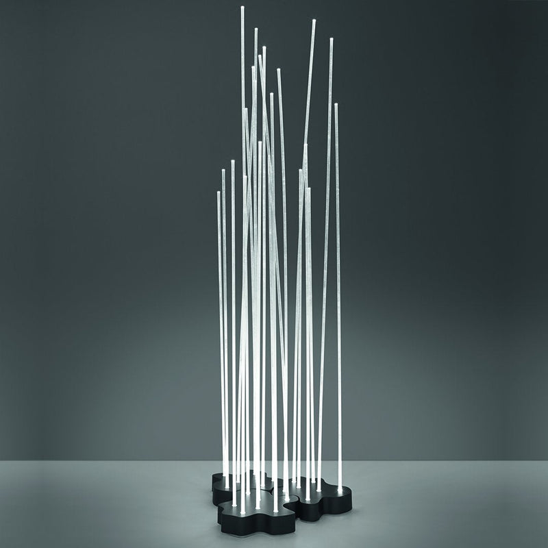 Modern metal sculpture with slim, vertical silver rods on a black base, showcasing a sleek, minimalist design.