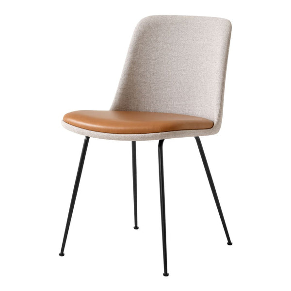 Beige fabric chair with a brown leather seat and black metal legs, featuring a sleek, modern design.