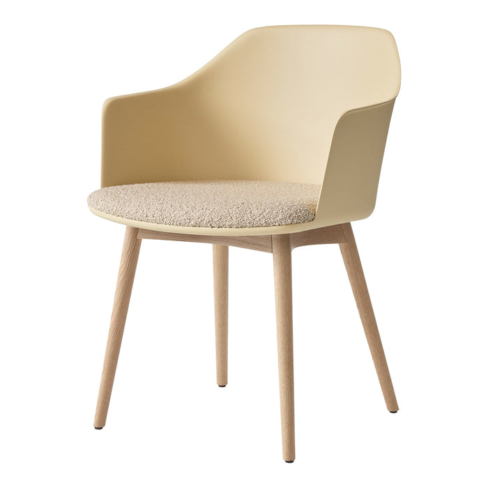 Light beige chair with a smooth plastic back and textured light brown fabric seat. Natural wood legs.