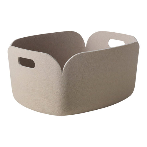 Beige storage basket with a textured finish and cut-out handles, featuring a modern design. Ideal for organization.