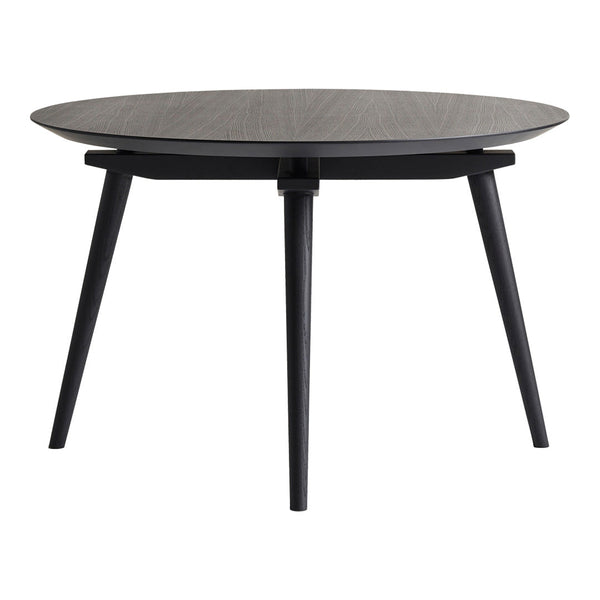 Round black coffee table with a textured dark wood top and sleek black legs, perfect for modern decor.