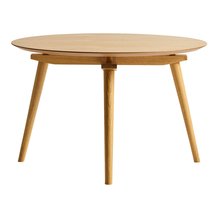 Round wooden table with a natural finish and simple, tapered legs. Clean, minimalistic design complements modern decor.