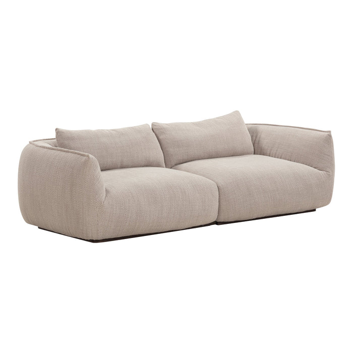 Light beige sofa with subtle textured fabric and soft, rounded shapes; ideal for modern living spaces.
