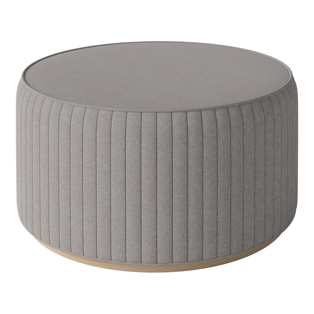 Round gray upholstered ottoman with vertical ribbed texture and wooden base. Ideal for modern decor.