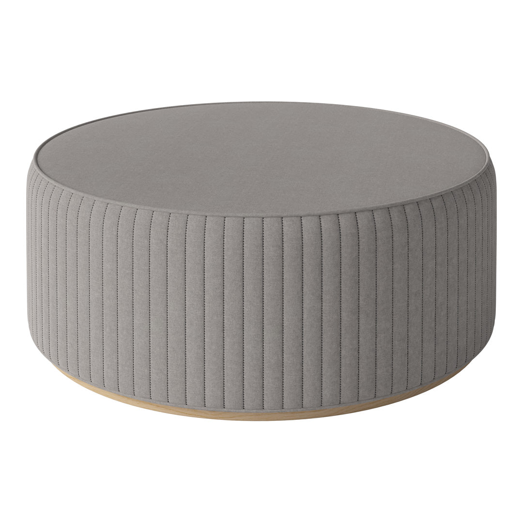 Gray ribbed round ottoman with a smooth top and light wooden base, perfect for modern decor.