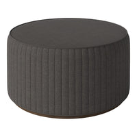 Gray ribbed round ottoman with a smooth top and wooden base, perfect for modern decor.