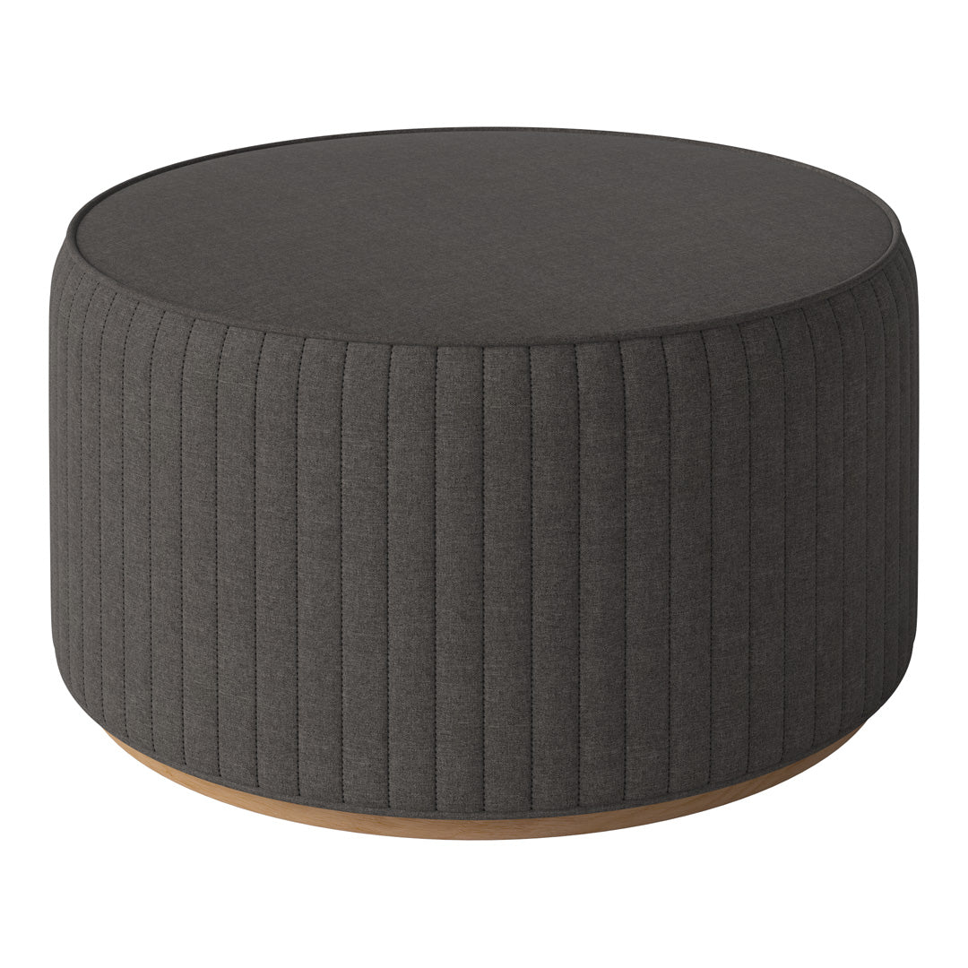 Round, dark gray ottoman with vertical ribbed texture and a wooden base, perfect for modern decor.