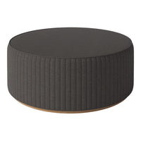 Round gray upholstered ottoman with vertical ribbed pattern and wooden base, perfect for modern decor.