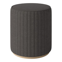 Round grey upholstered stool with vertical ribbed pattern and a light wood base. Ideal for modern decor.