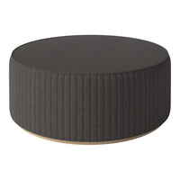 Round dark gray ottoman with vertical ribbed texture and wooden base, perfect for modern decor.