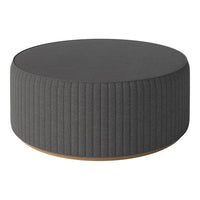 Gray ribbed round ottoman with a smooth wooden base, perfect for modern home decor.