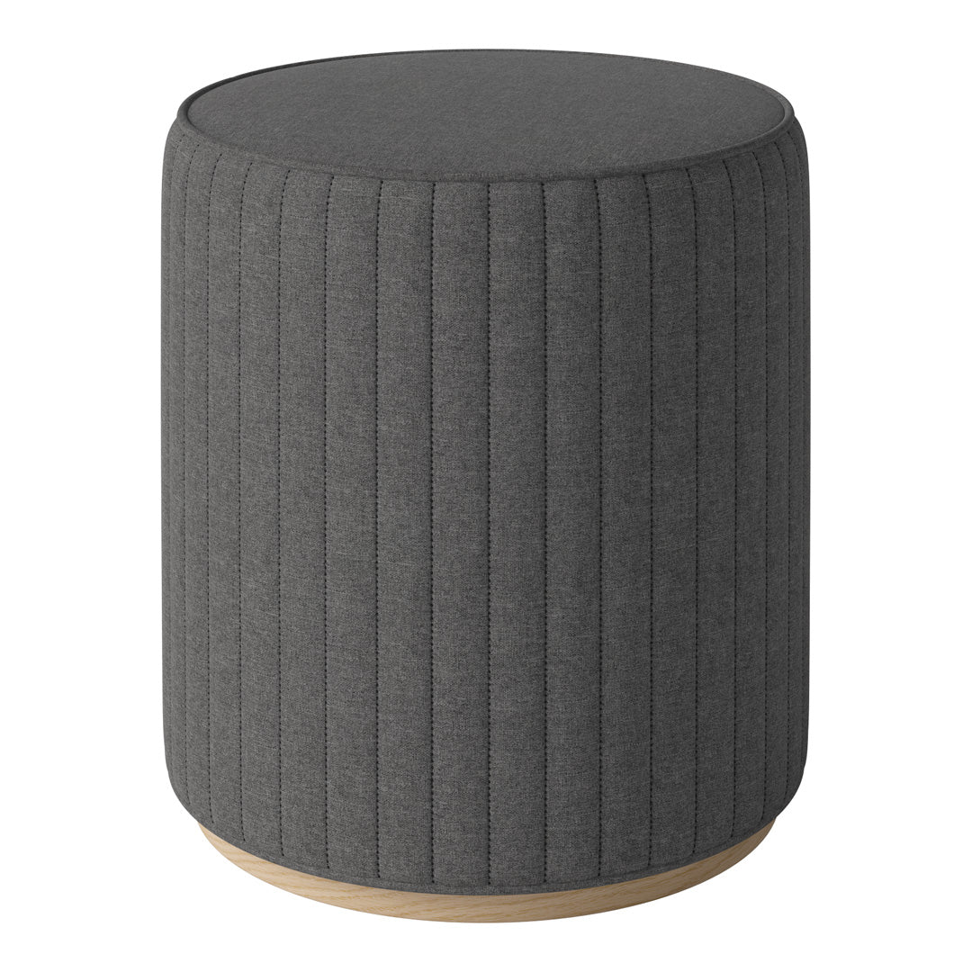 Gray upholstered round stool with vertical ribbed texture and light wood base. Stylish and modern accent piece.