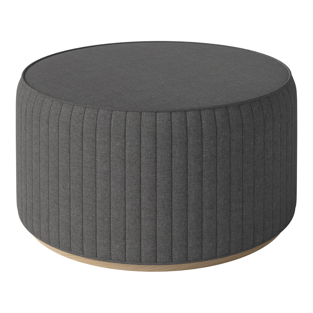 Round gray ottoman with vertical ribbed pattern and light wooden base. Modern and stylish accent piece.