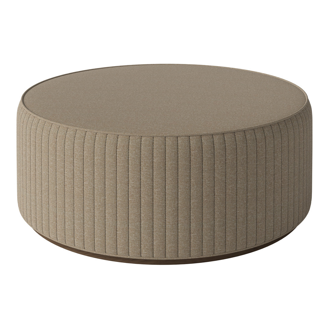Beige round ottoman with textured ribbed fabric and a smooth top surface, ideal for modern decor.
