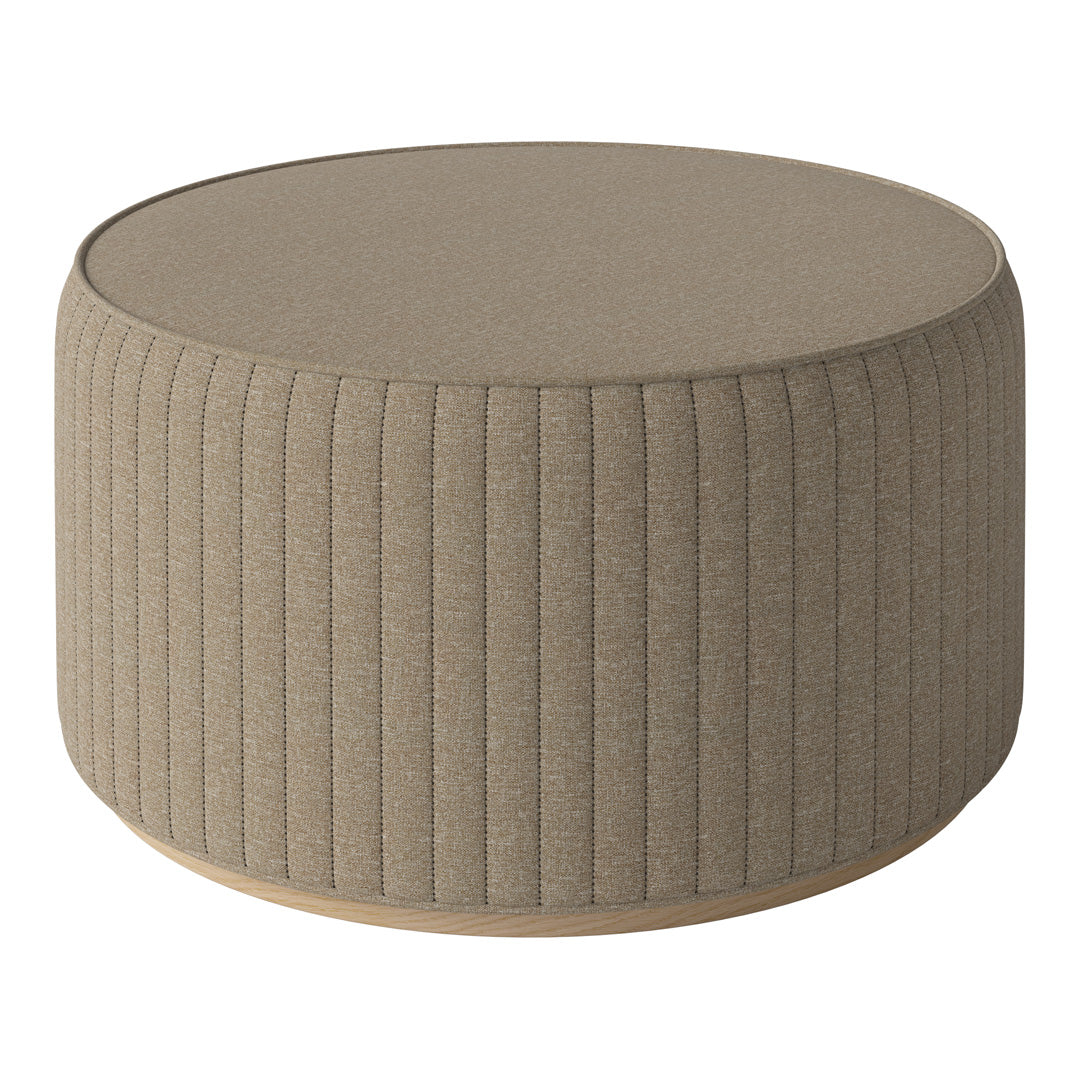 Round beige ottoman with vertical ribbed texture and a smooth top, perfect for modern decor.