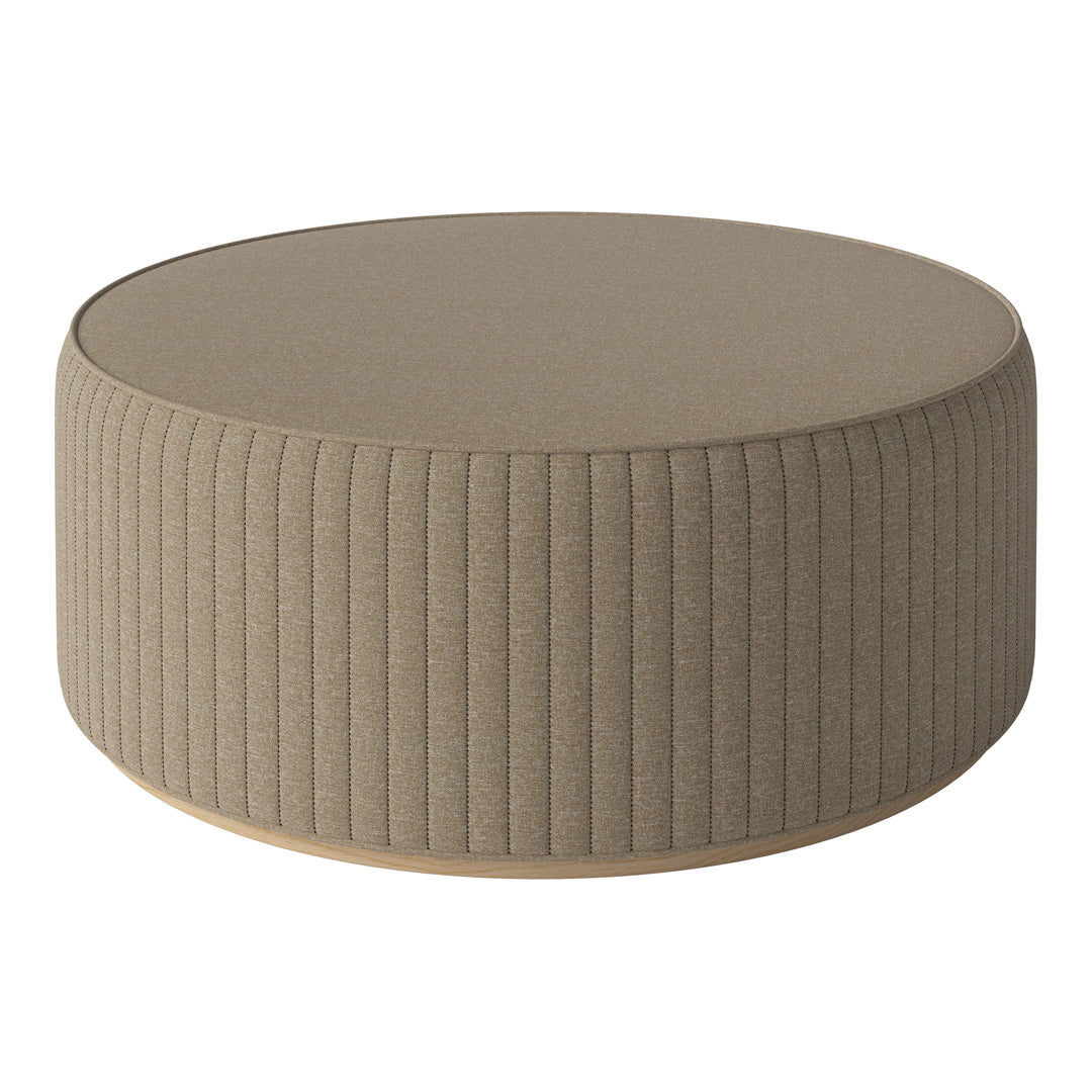 Round beige ottoman with vertical ribbed pattern and smooth top surface, perfect for modern decor.