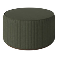 Green upholstered round ottoman with vertical ribbed texture and a wooden base. Ideal for modern decor.