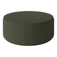 Round green ottoman with vertical ribbed pattern, perfect for modern decor.