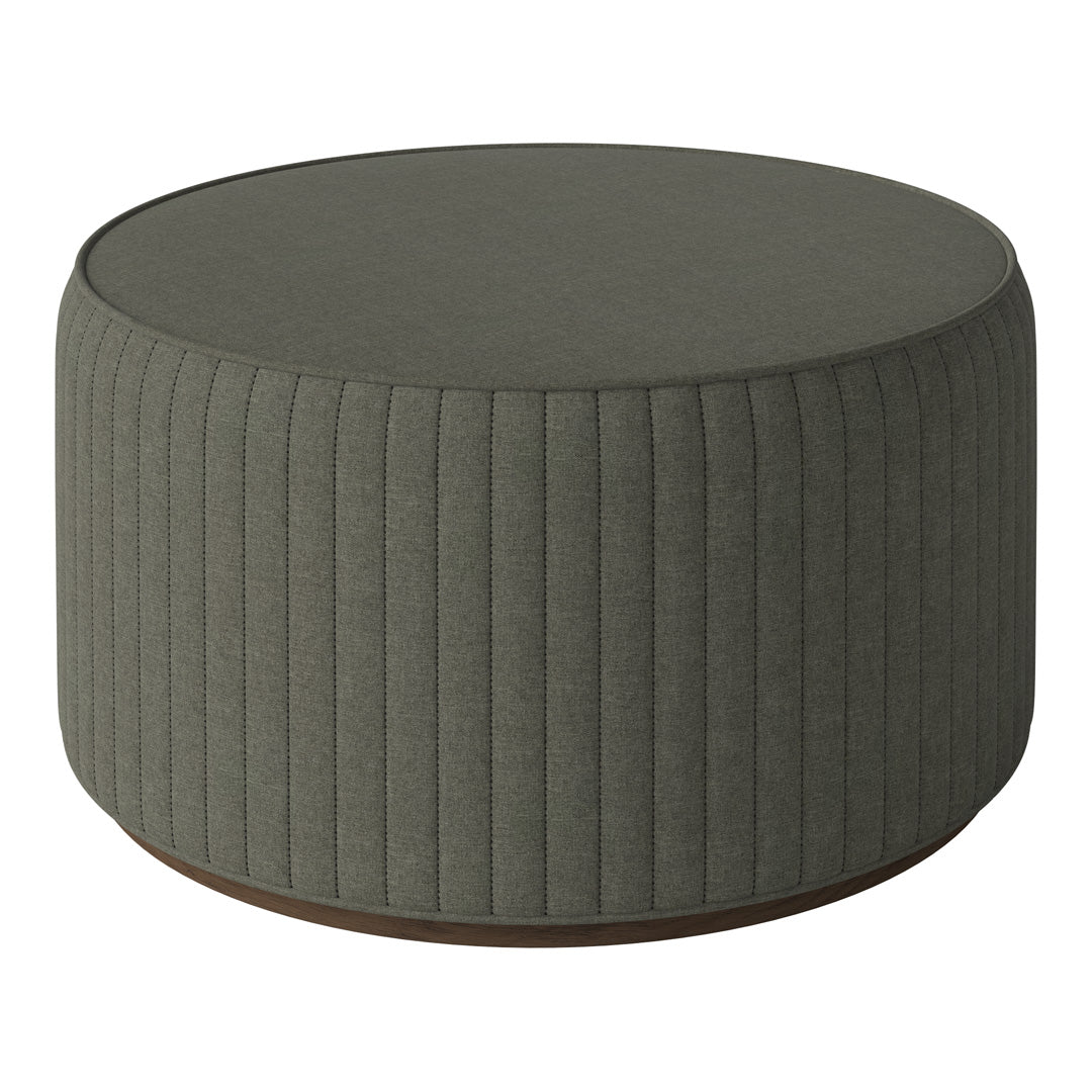 Round ottoman in muted green fabric with vertical ribbed texture and a contrasting wooden base.