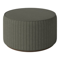 Round ottoman in muted green fabric with vertical ribbed texture and a contrasting wooden base.