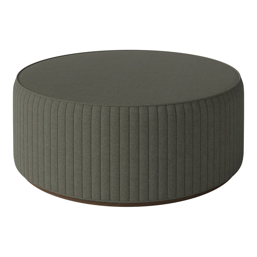 Green round ottoman with vertical ribbed fabric and a wooden base. Perfect for modern decor.