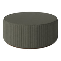 Green round ottoman with vertical ribbed fabric and a wooden base. Perfect for modern decor.