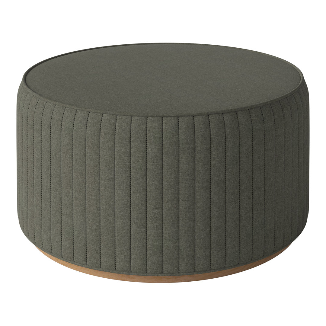 Green ribbed round ottoman with a light wooden base, adding a touch of modern elegance to any space.