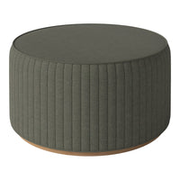 Green ribbed round ottoman with a light wooden base, adding a touch of modern elegance to any space.