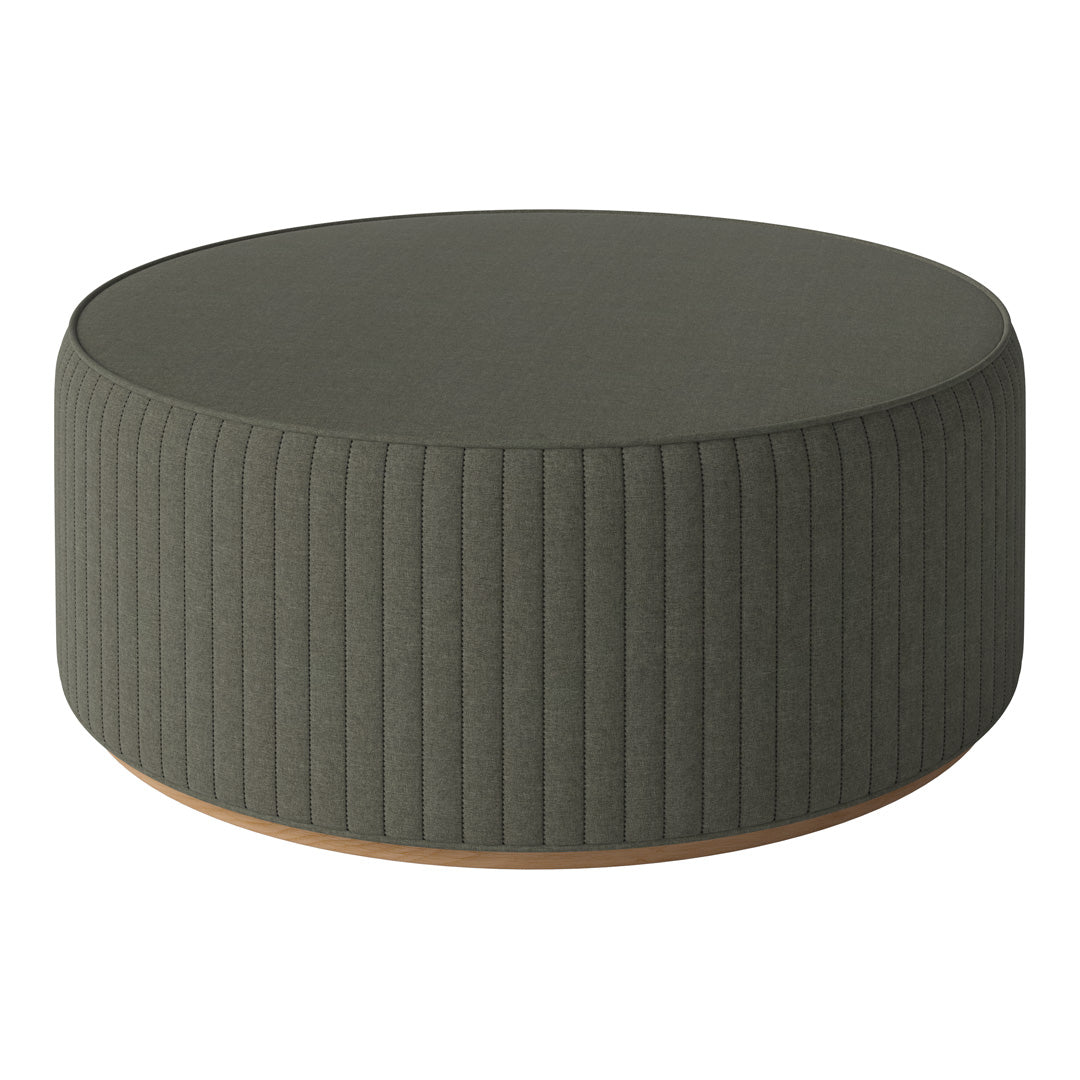 Round ottoman in muted olive green with vertical ribbed pattern and natural wooden base. Modern, stylish design.