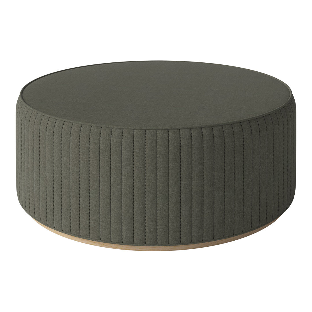 Round green ottoman with vertical ribbed pattern and a smooth wooden base. Perfect for modern decor.