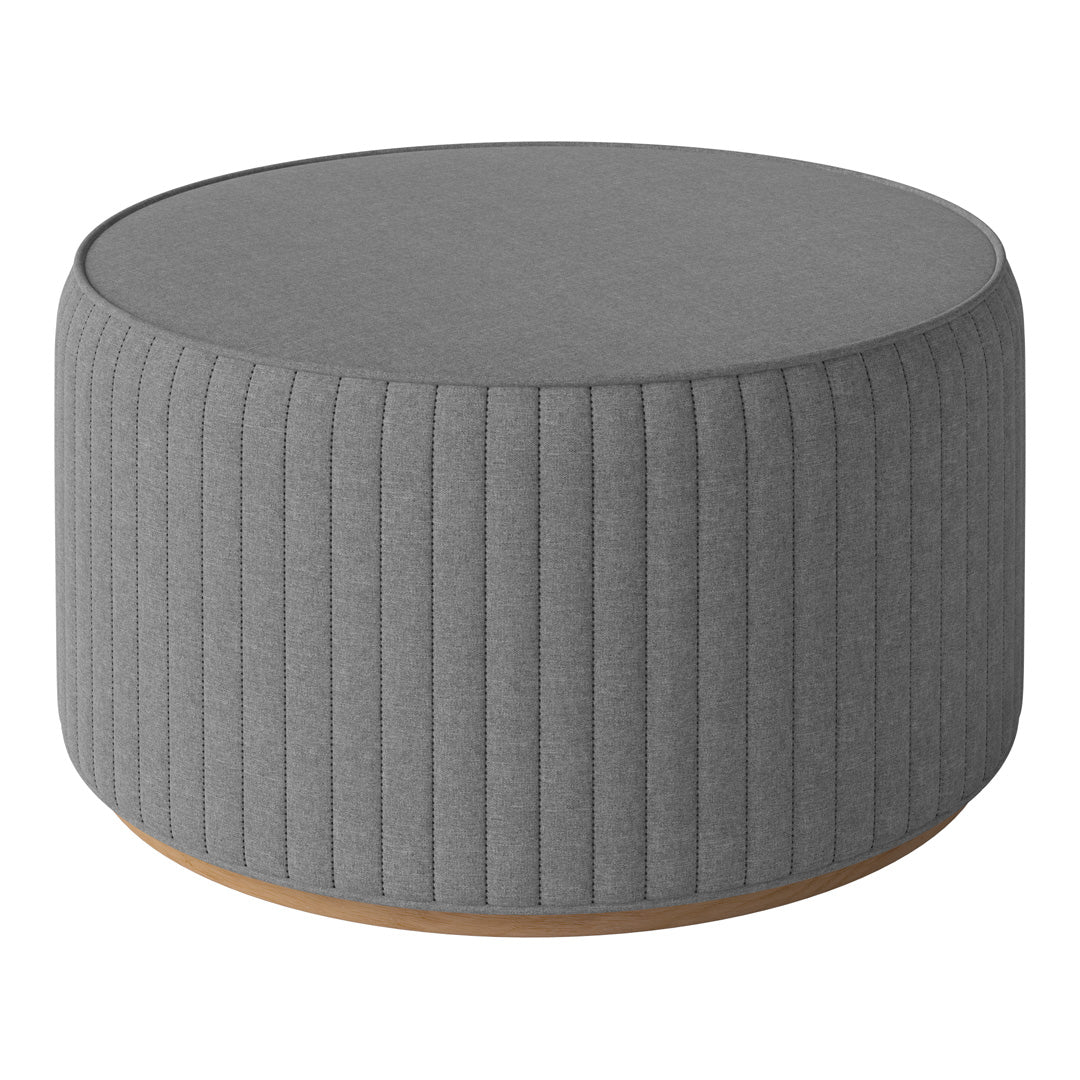 Gray round ottoman with vertical ribbed texture and light wood base, perfect for modern decor.