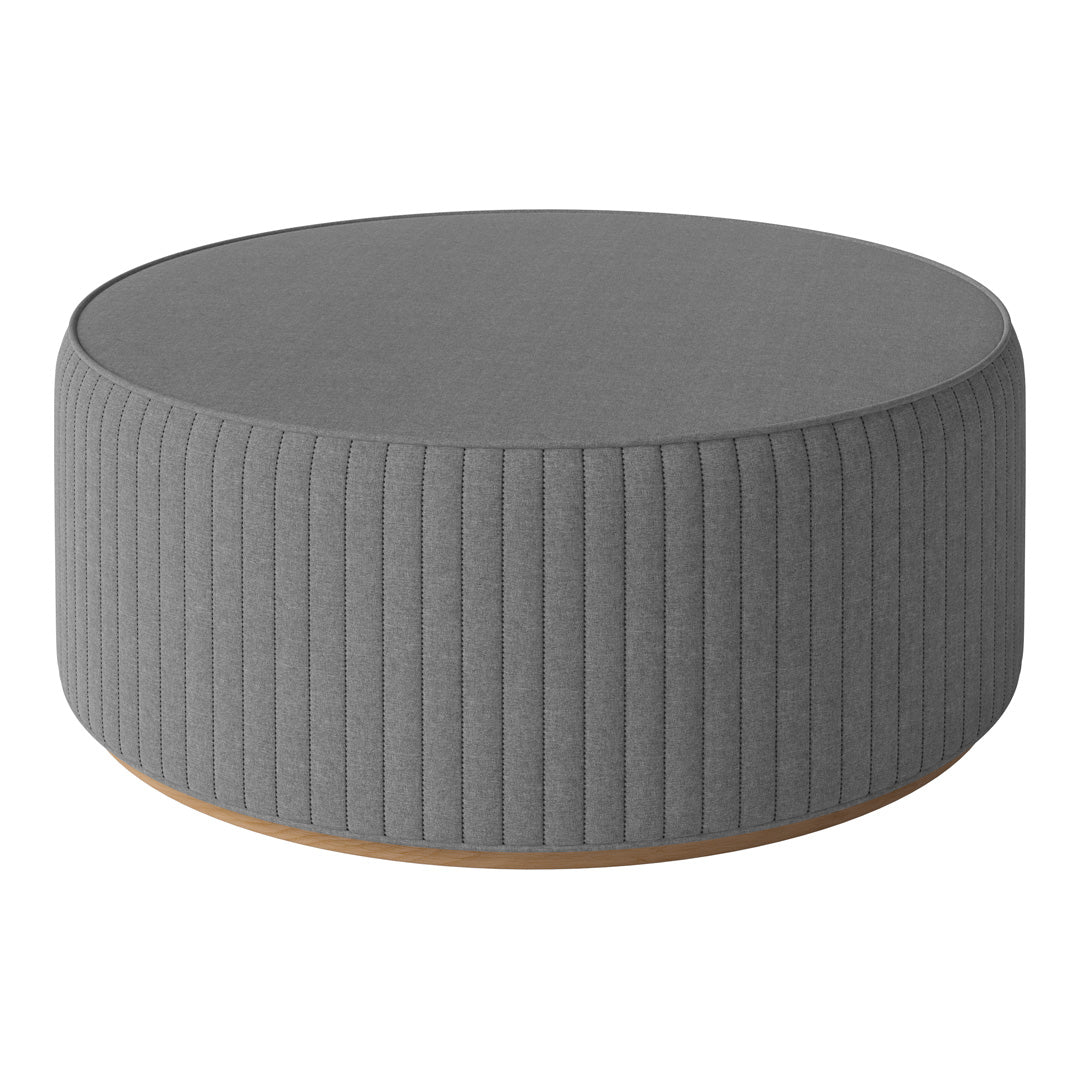 Round gray ottoman with vertical ribbed texture and a natural wood base. Perfect for modern decor.