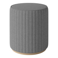 Gray upholstered round stool with vertical ribbed pattern and a natural wood base. Perfect for modern decor.