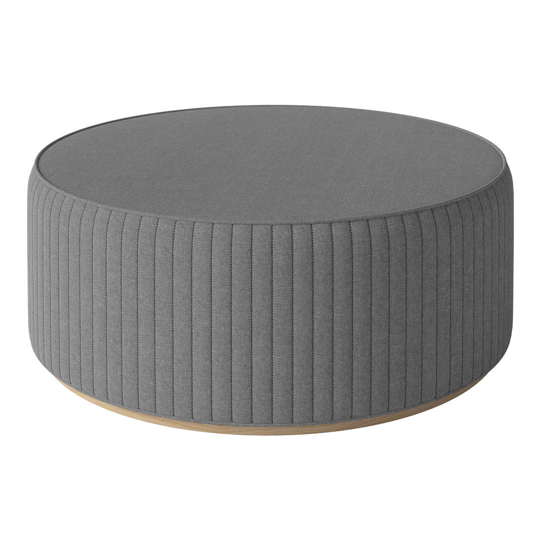 Gray round ottoman with ribbed texture and wooden base, perfect for modern living spaces.