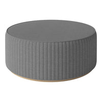 Gray round ottoman with ribbed texture and wooden base, perfect for modern living spaces.