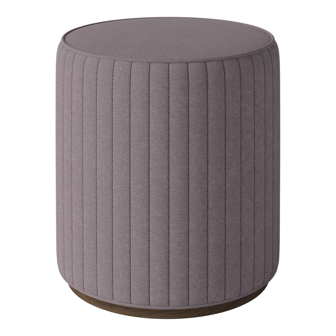 Round taupe ottoman with vertical ribbed pattern and wooden base, adding texture and warmth to modern decor.