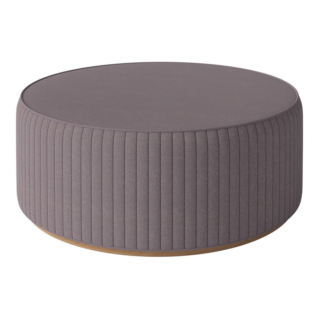 Round gray ottoman with vertical ribbed texture and a sleek wooden base. Perfect for modern decor.