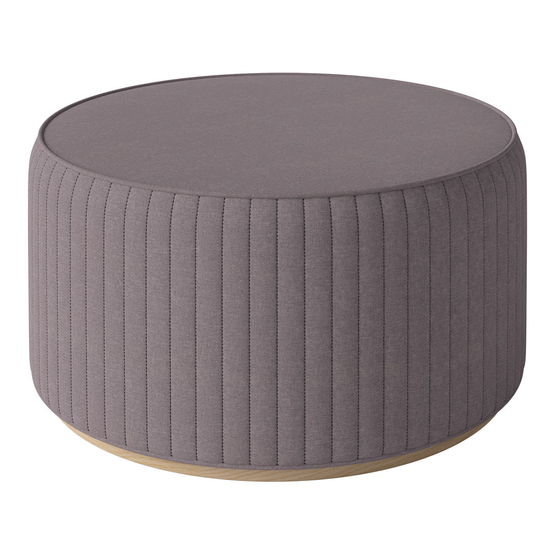 Round gray upholstered ottoman with vertical ribbed pattern and wooden base. Ideal for modern decor.
